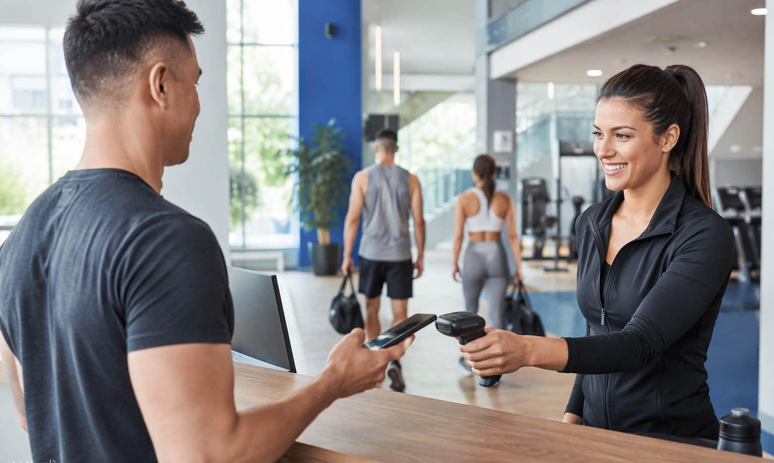 Front desk staff scanning a member's phone at check-in